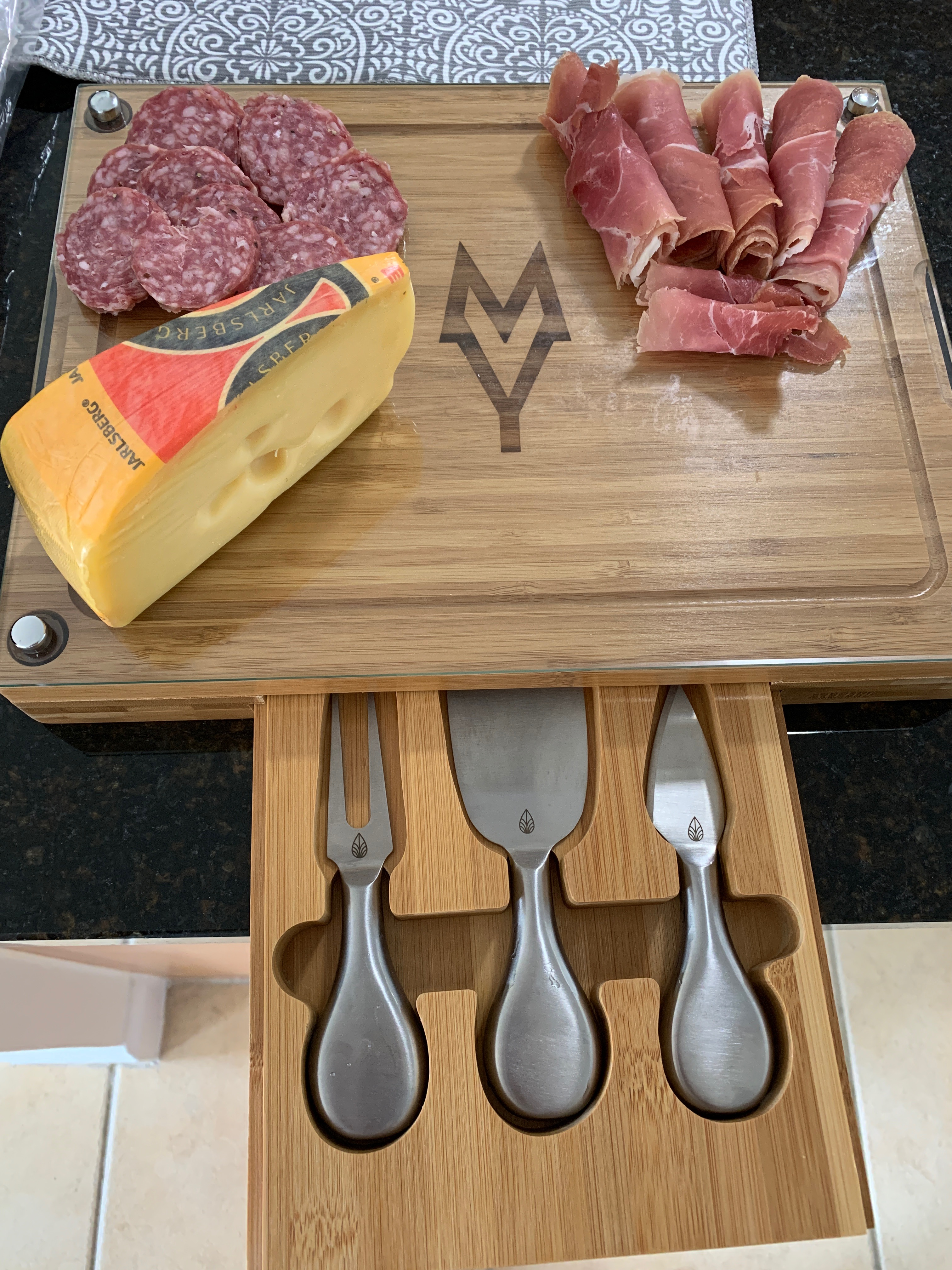 Custom monogram design laser-cut cheeseboard for personalized wedding present.